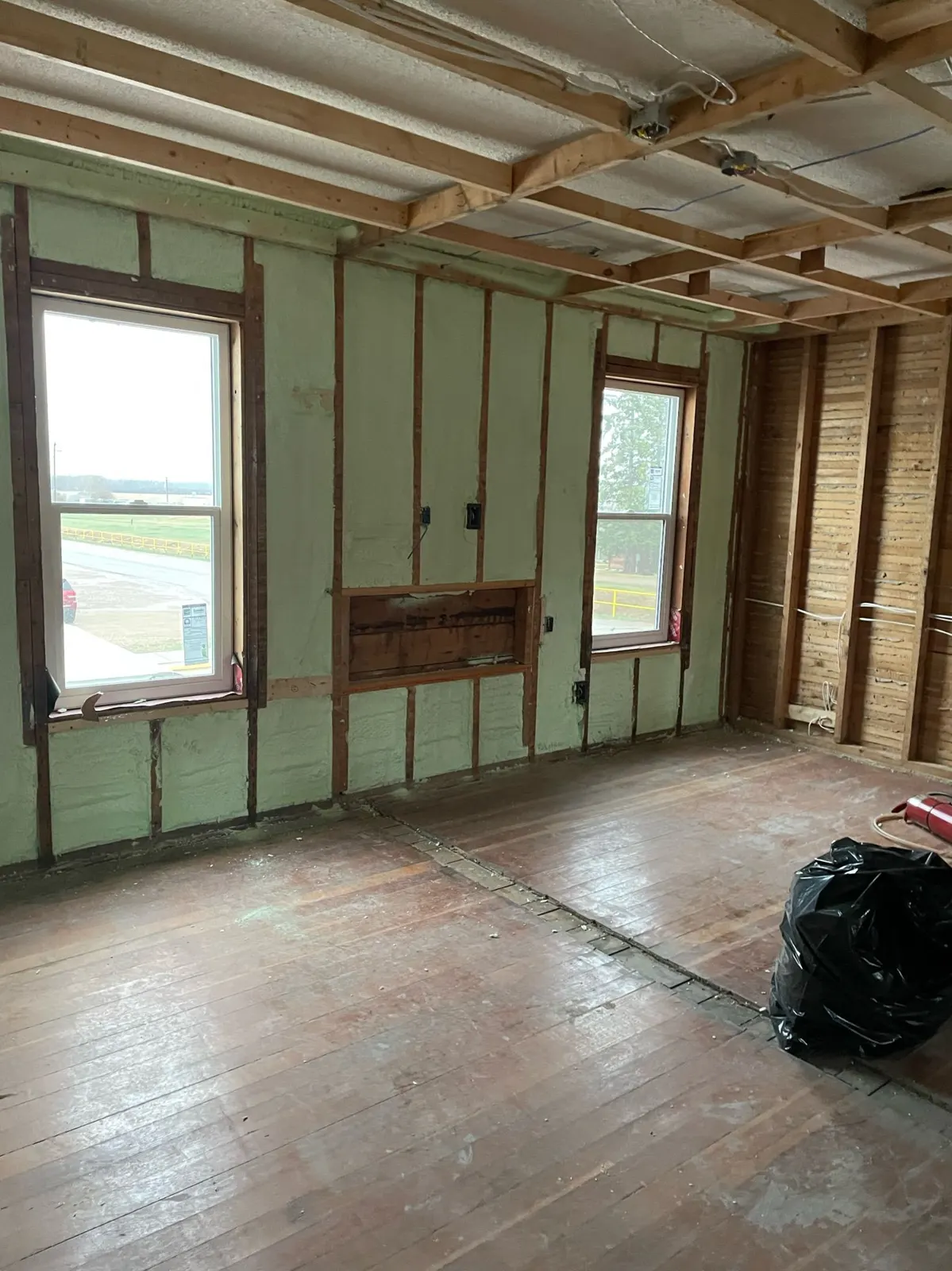 House under renovation with spray foam sprayed into the exterior wall framing