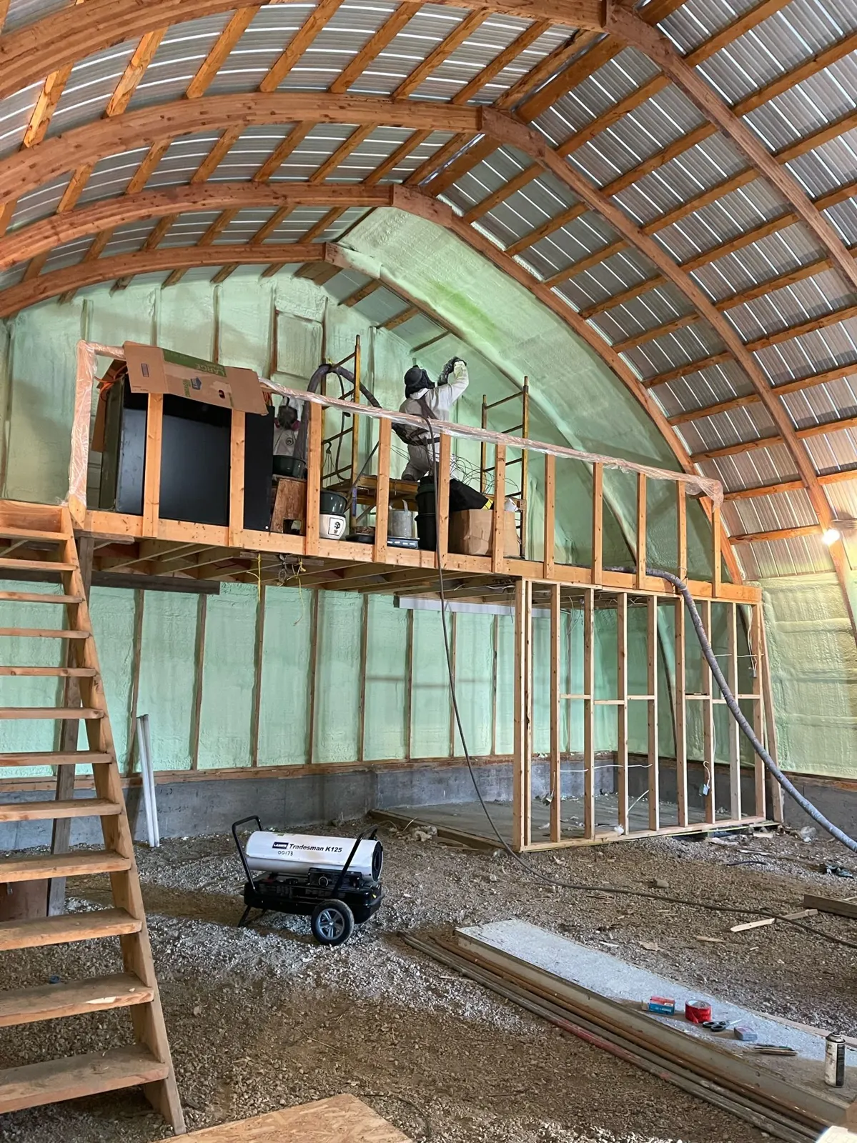 Farm building interior with spray foam on the ceiling and walls