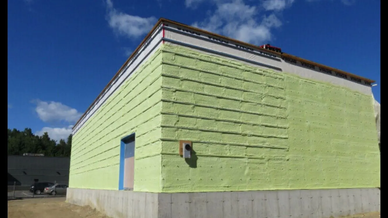 Large school exterior wall covered in closed cell spray foam