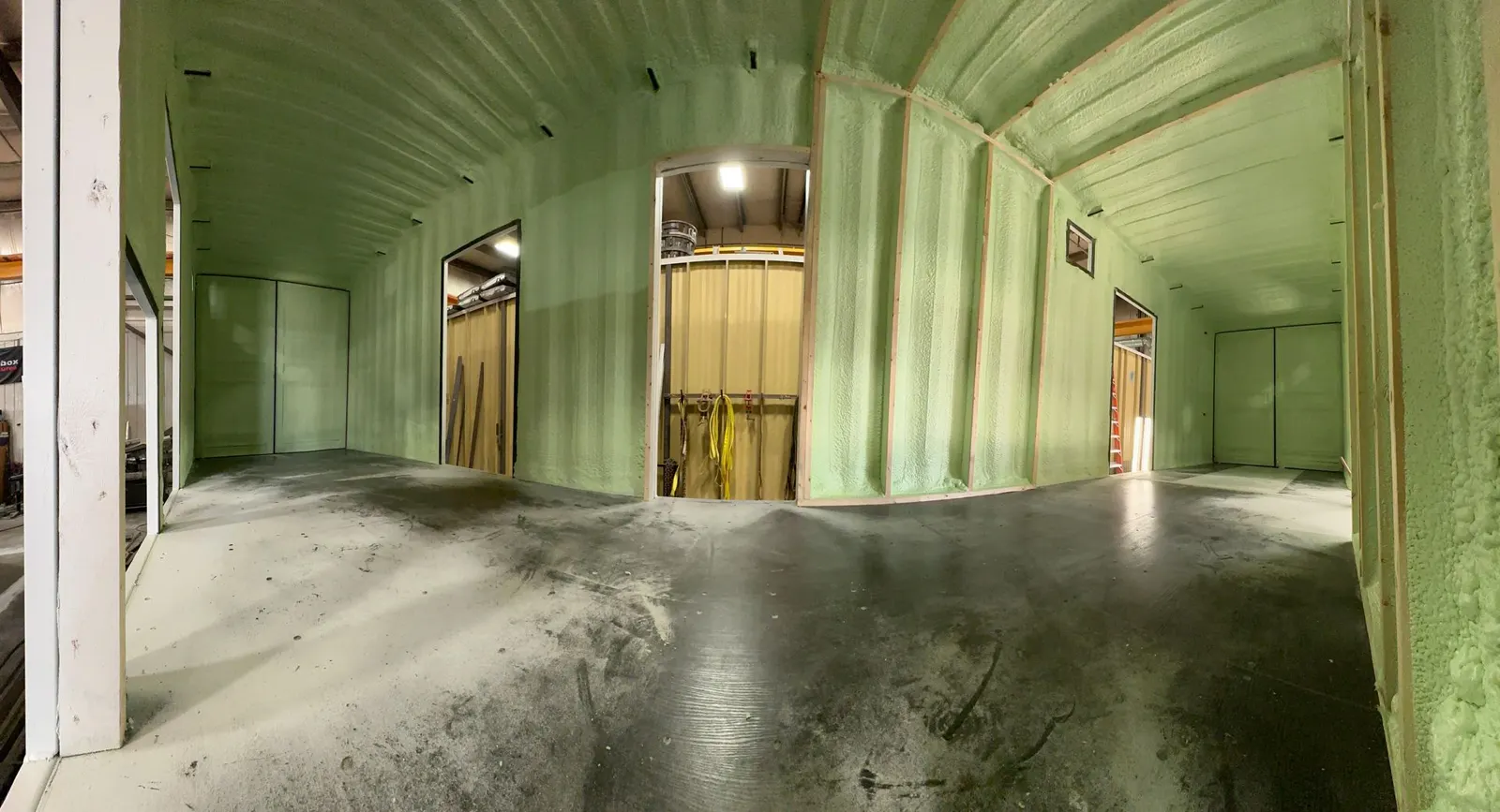 Large commercial shop with walls and ceiling finished in closed cell spray foam