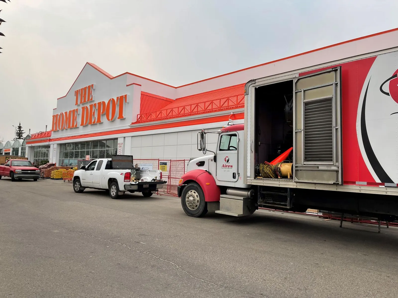Aires spray foam rig and trailer parked outside a commercial building