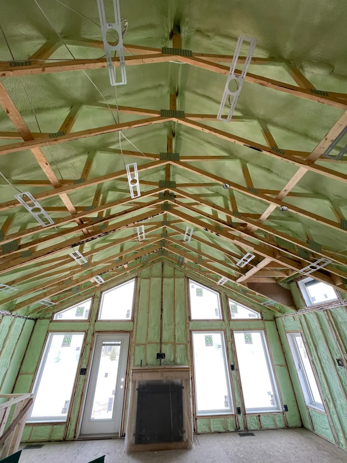 Vaulted ceiling and gable wall insulated with green closed cell spray foam